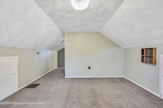 bonus room featuring carpet and lofted ceiling