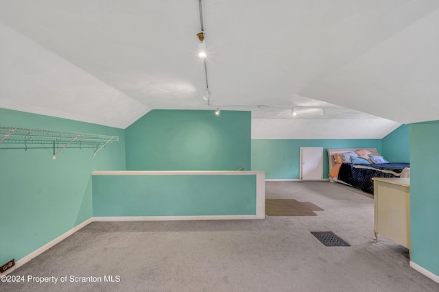 additional living space featuring light carpet and lofted ceiling