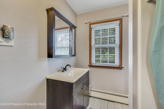 bathroom featuring vanity and a baseboard heating unit