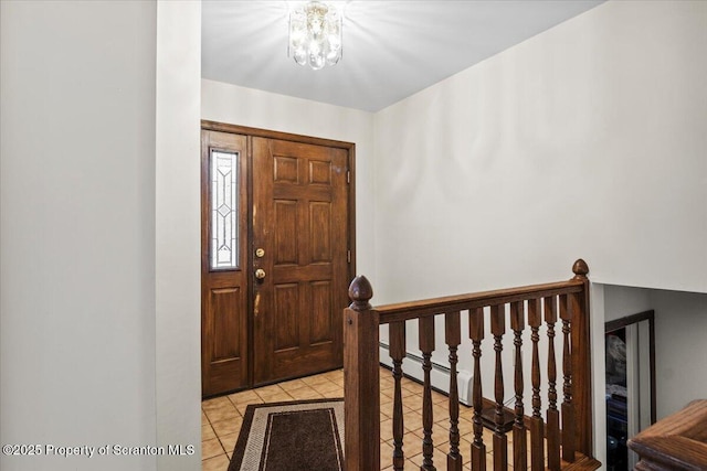 entryway featuring a notable chandelier and light tile patterned flooring