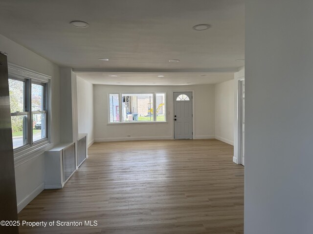 foyer with recessed lighting, baseboards, and light wood-style flooring