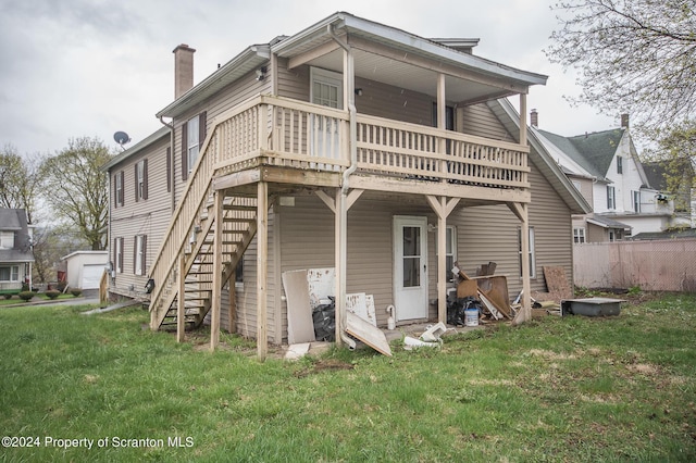 rear view of house featuring a lawn