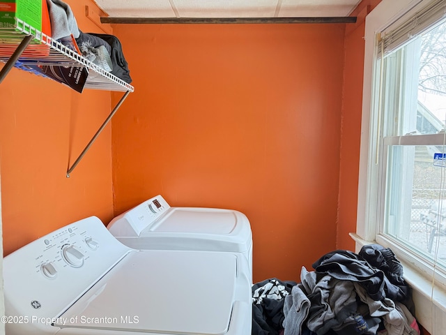 clothes washing area with separate washer and dryer