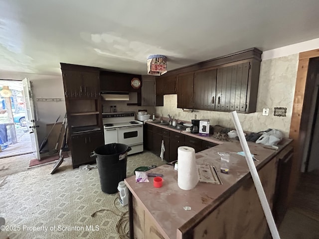 74 Matthews Rd, Spring Brook Twp, PA 18444 - kitchen with electric stove, under cabinet range hood, dark brown cabinets, and a peninsula