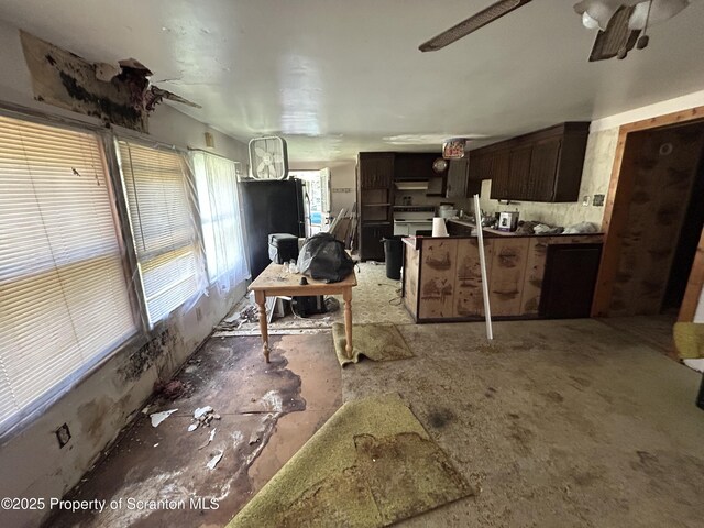 74 Matthews Rd, Spring Brook Twp, PA 18444 - kitchen with under cabinet range hood, range, dark brown cabinets, a ceiling fan, and dark countertops