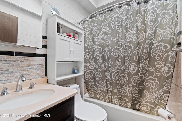 full bathroom featuring vanity, shower / bath combination with curtain, and toilet