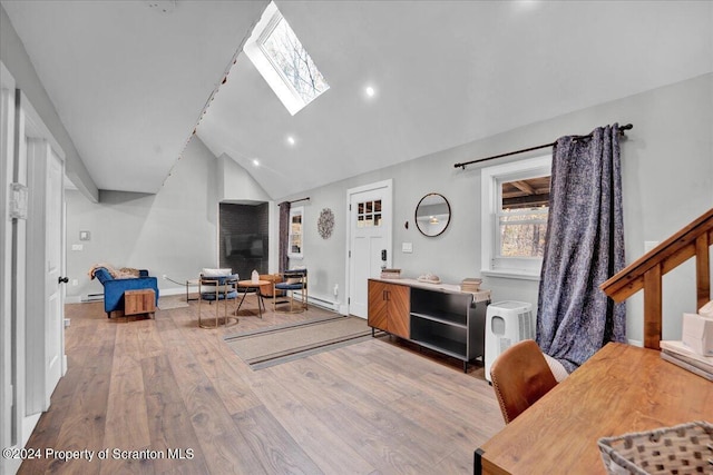 living room with wood-type flooring, baseboard heating, and vaulted ceiling with skylight