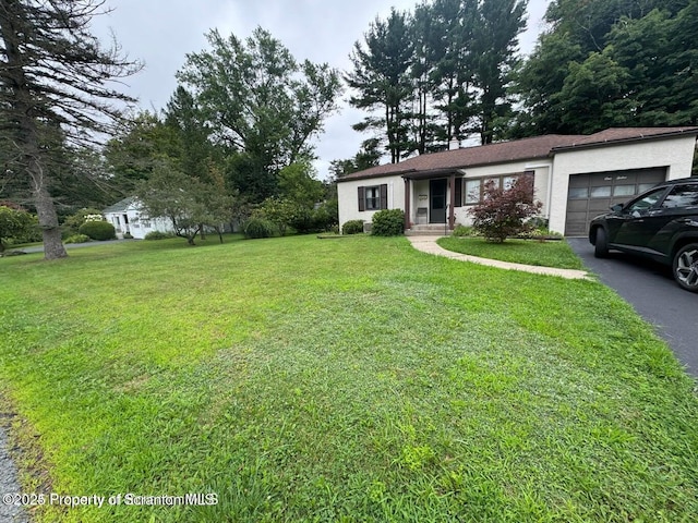 ranch-style home with stucco siding, driveway, an attached garage, and a front yard