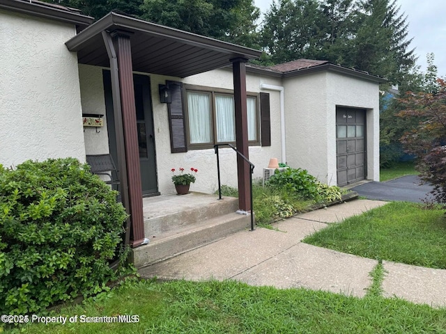 exterior space with stucco siding and an attached garage