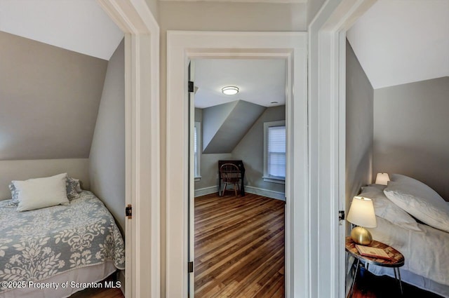 bedroom featuring vaulted ceiling, wood finished floors, and baseboards