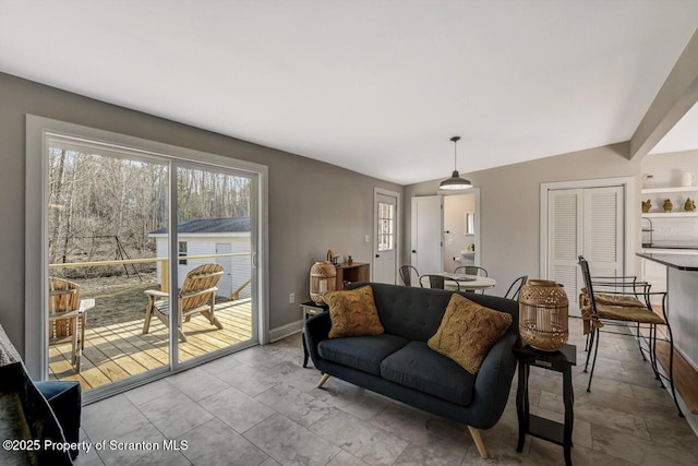 living area featuring baseboards