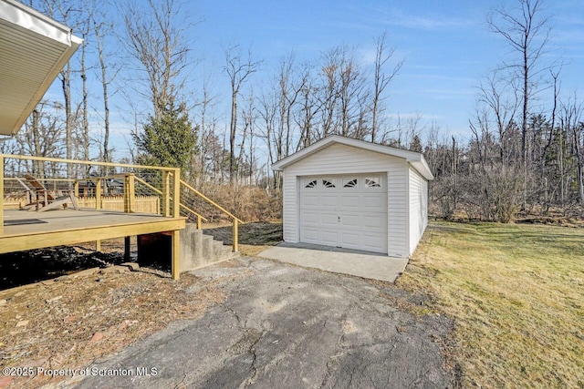 detached garage featuring driveway