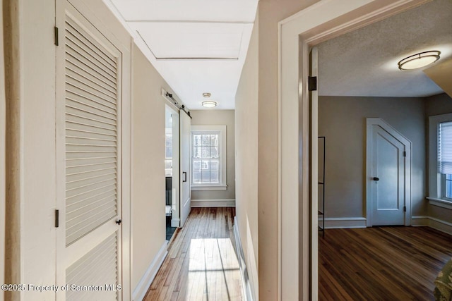 hall with wood finished floors and baseboards