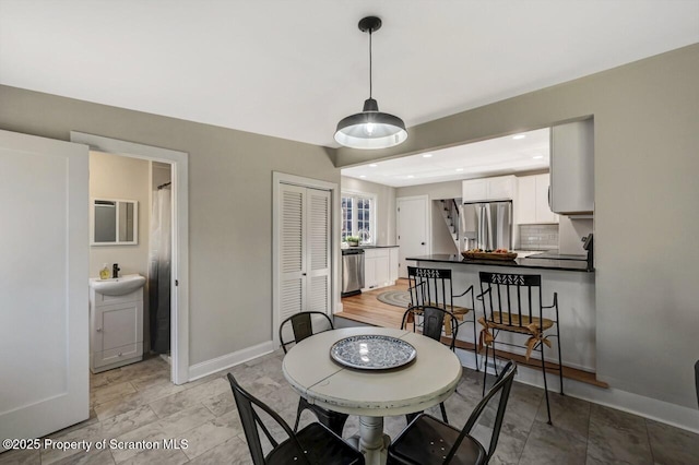 dining room featuring recessed lighting and baseboards