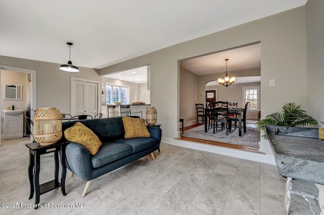 living room with an inviting chandelier and baseboards