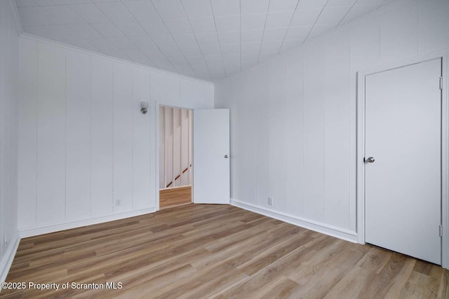 empty room with light hardwood / wood-style floors