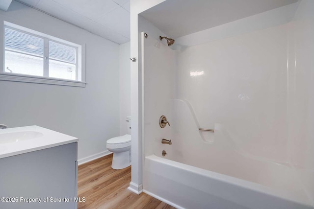 full bathroom with shower / tub combination, hardwood / wood-style floors, vanity, and toilet