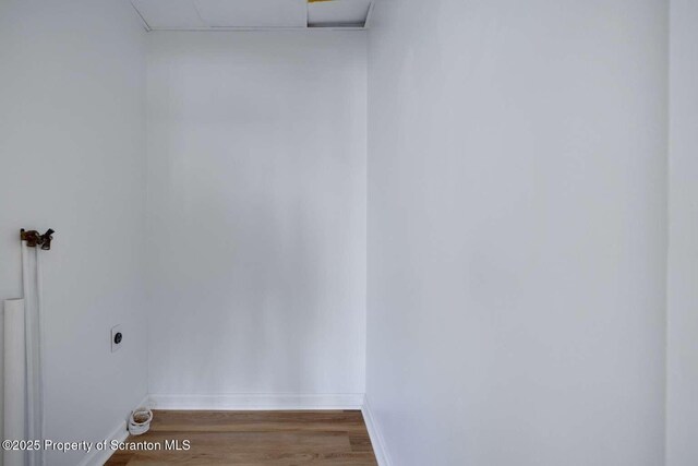 interior space featuring hardwood / wood-style floors and a drop ceiling