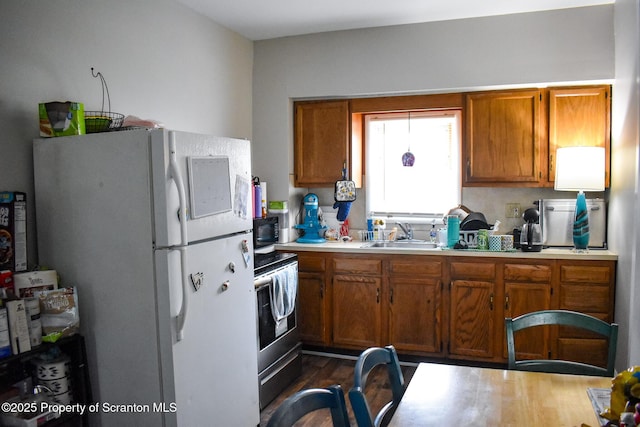640 Alder St, Scranton, PA 18505 - kitchen with freestanding refrigerator, black microwave, light countertops, a sink, and stainless steel electric range oven