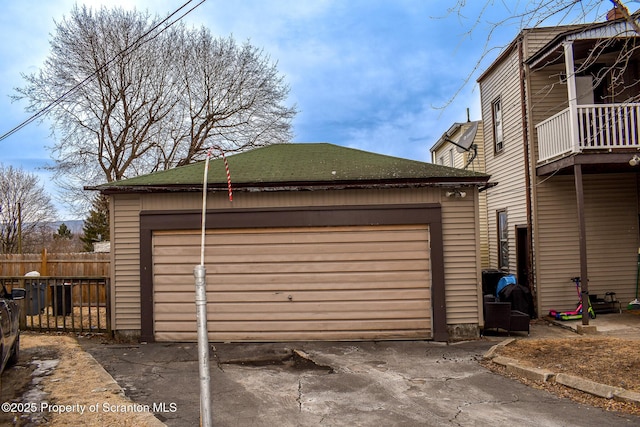 detached garage featuring fence