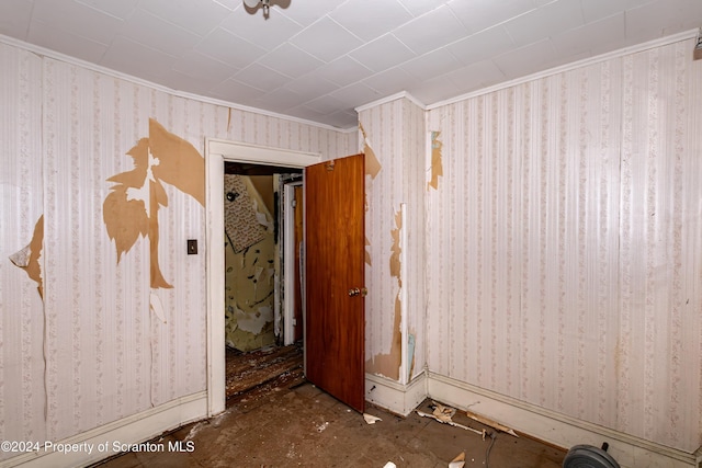 unfurnished room featuring crown molding