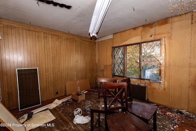 miscellaneous room featuring radiator heating unit and wooden walls