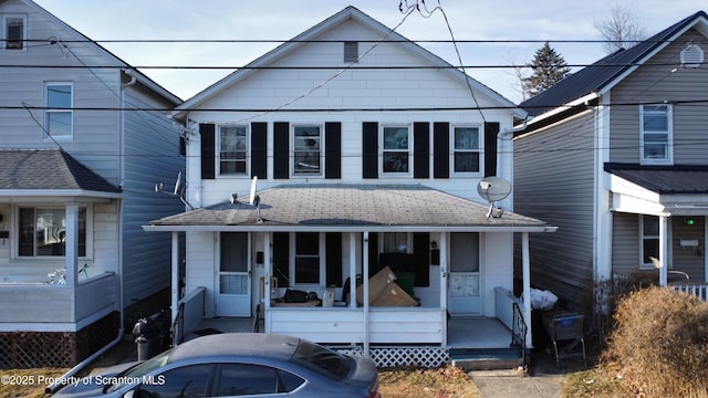 view of front of home with a shingled roof and covered porch