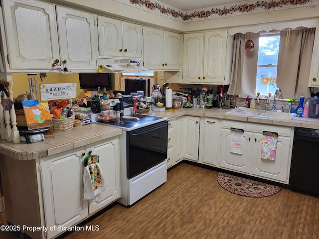 kitchen featuring dark wood-style flooring, under cabinet range hood, range with electric stovetop, and dishwasher