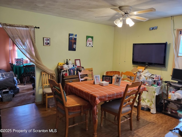 dining area with ceiling fan and wood finished floors