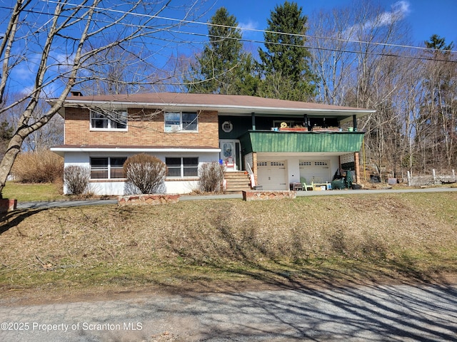 bi-level home featuring brick siding and an attached garage