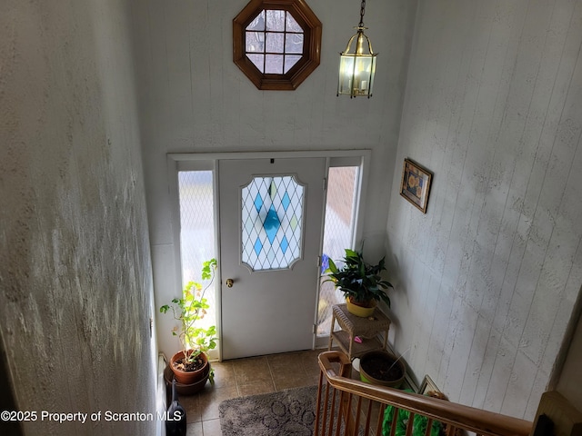 entrance foyer featuring tile patterned flooring and a wealth of natural light