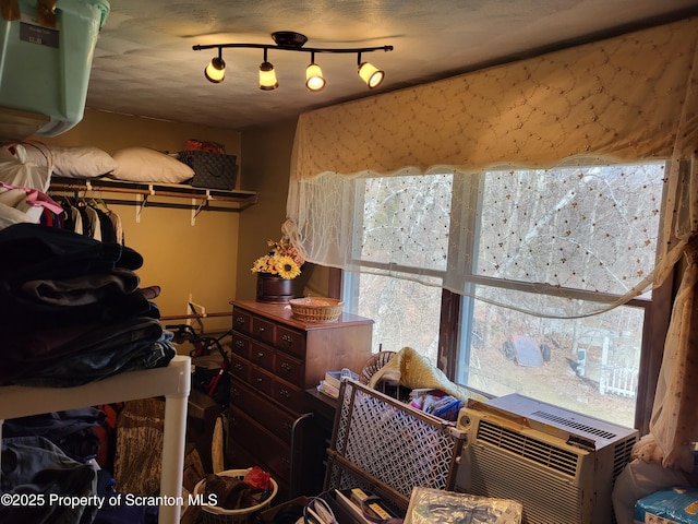 bedroom featuring rail lighting