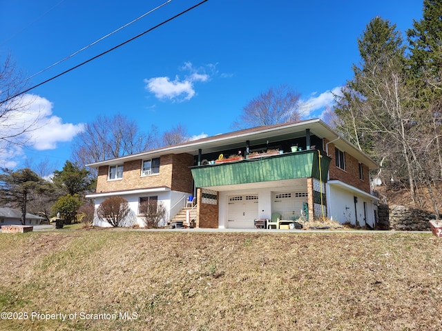 view of front of home featuring an attached garage and brick siding