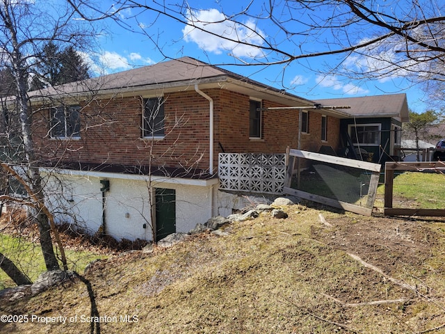 view of side of property with brick siding