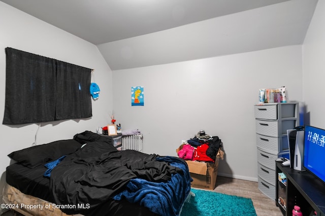 bedroom with radiator heating unit and vaulted ceiling