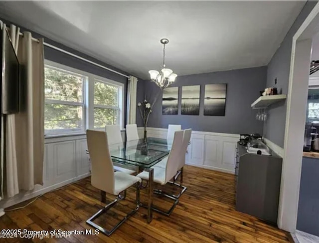 9340 Fairmount Way, Tobyhanna, PA 18466 - dining area with a chandelier, wood finished floors, plenty of natural light, wainscoting, and a decorative wall