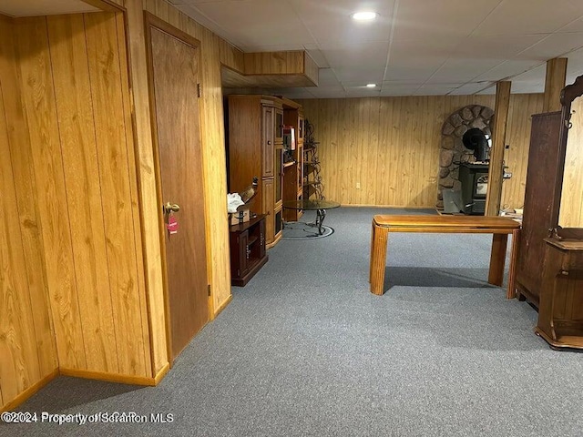 interior space with wood walls and carpet floors