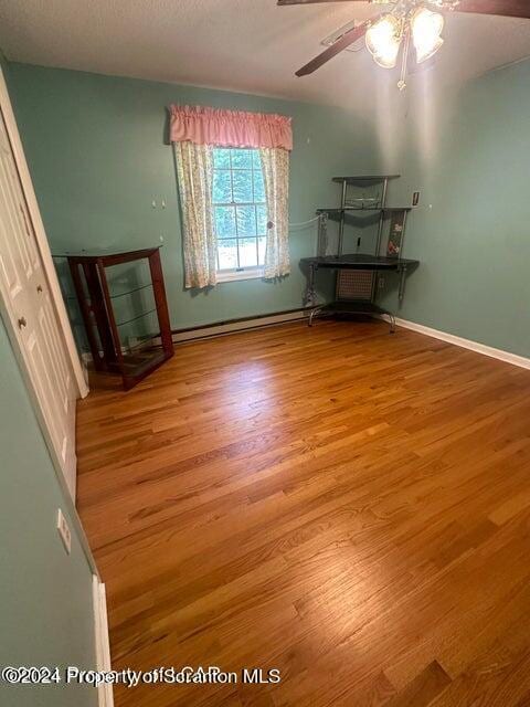 interior space with ceiling fan and light hardwood / wood-style floors