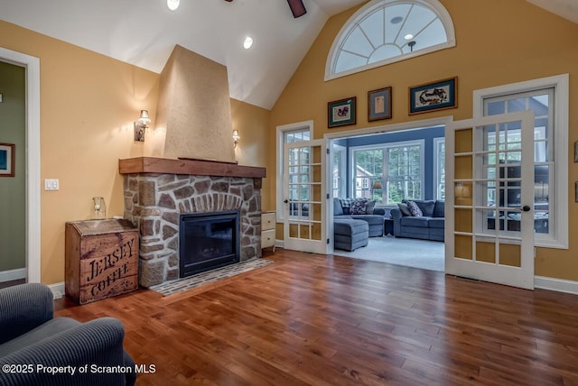 268 Winship Rd, Covington Twp, PA 18444 - living area featuring wood finished floors, french doors, a stone fireplace, high vaulted ceiling, and a ceiling fan
