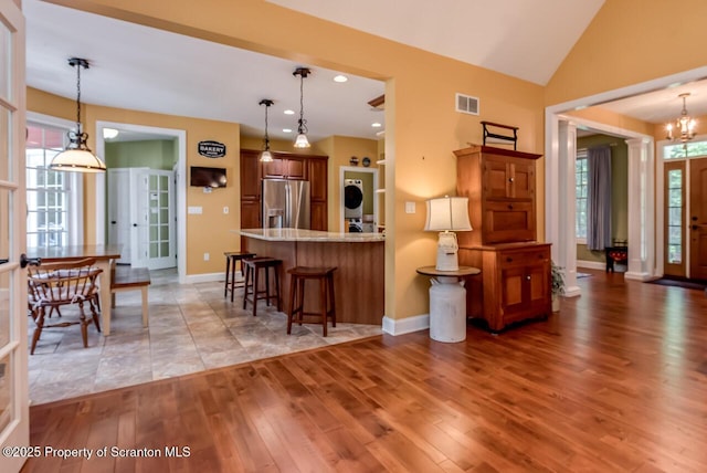 268 Winship Rd, Covington Twp, PA 18444 - kitchen featuring stainless steel fridge with ice dispenser, light wood-type flooring, a breakfast bar, a peninsula, and pendant lighting