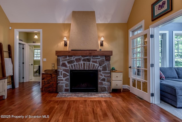 268 Winship Rd, Covington Twp, PA 18444 - living room with wood finished floors, lofted ceiling, and a stone fireplace