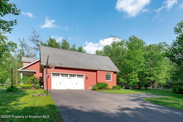 268 Winship Rd, Covington Twp, PA 18444 - view of side of home with an attached garage, asphalt driveway, a yard, and a shingled roof
