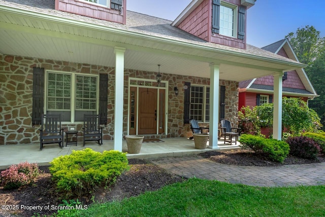 268 Winship Rd, Covington Twp, PA 18444 - doorway to property with covered porch, stone siding, and a shingled roof