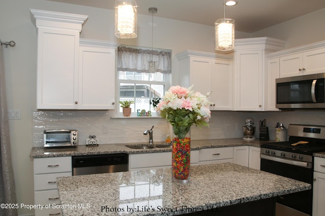 kitchen featuring appliances with stainless steel finishes, a sink, and white cabinets