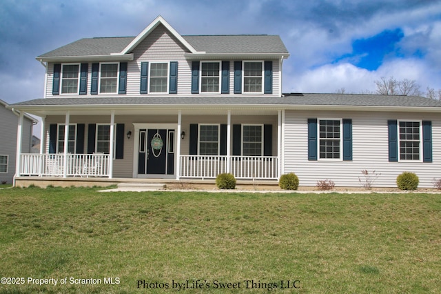 colonial home featuring a porch and a front lawn