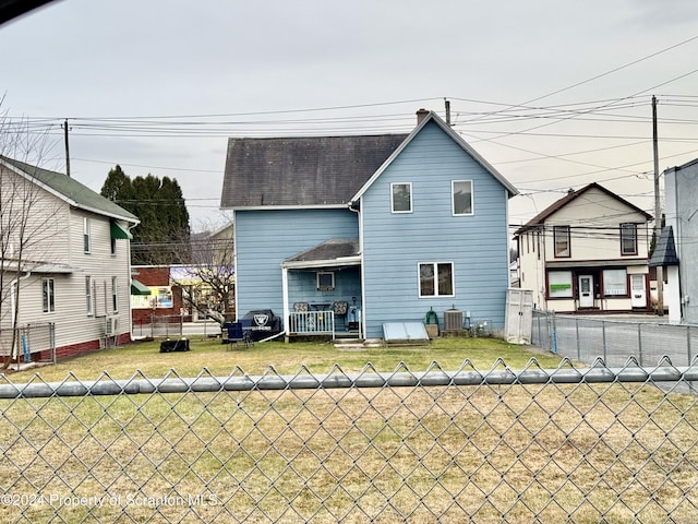 rear view of property with a lawn