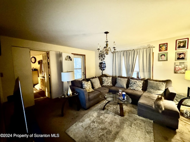 carpeted living room with a notable chandelier