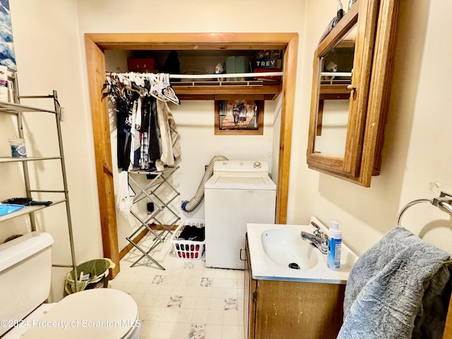 bathroom with washer / clothes dryer, vanity, and toilet