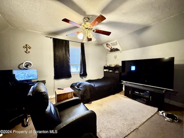 living room featuring a textured ceiling, ceiling fan, carpet, and lofted ceiling