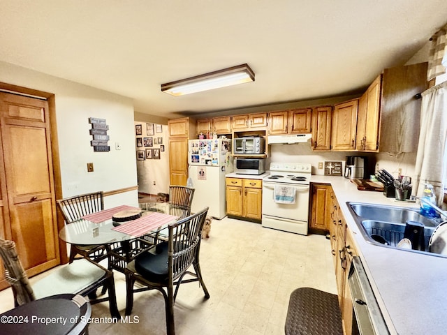 kitchen with white appliances and sink